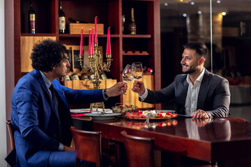 Two businessmen raising their glasses