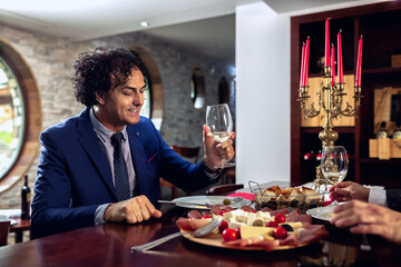 Businessman holding a wine glass during dinner time