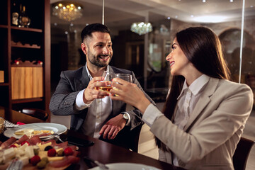 Cheers, businessman and a businesswoman having a drink