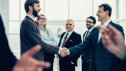 confident business people shaking hands with each other.