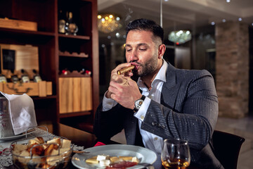 Businessman enjoying his expensive cigar
