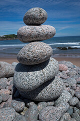 Fototapeta na wymiar Gneiss rocks dot the coast lines of Cape Breton Highlands National Park. Some are used to form creative art forms.