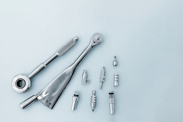 Dental implantation tools: reversible key, torque wrench on a blue background.