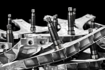 Close-up view of stainless steel hardware components on black background