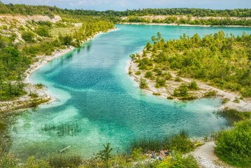 Karlstrup Kalkgravis is a natural lake that took over an old limestone quarry. People sitting enjoy...