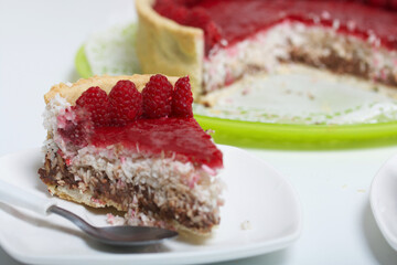 Levington sliced cake with raspberry jelly, chocolate and coconut. Garnished with raspberries.