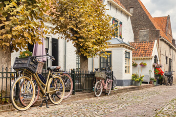 Fototapeta na wymiar Ttiny old houses with bicycles in the Dutch hanseatic city of Elburg, The Netherlands