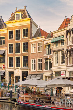 The Dutch Oude Rijn canal with terrace boat, bars, restaurants and shops in the ancient city center of Leiden, The Netherlands on January 16, 2020