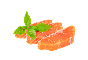 Piece of fresh salmon fillet sliced with leaf basil isolated on white background