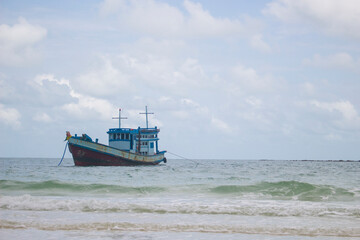 Fishing boat in the sea and cloudy sky, wave sea. Landscape.