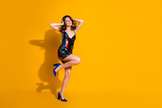 Full length body size view of her she nice-looking attractive dreamy cheerful cheery wavy-haired lady having fun dancing nightlife isolated bright vivid shine vibrant yellow color background