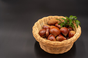 Obraz premium chestnuts and harbs in bascket