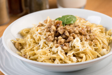 Turkish Noodle / Eriste with cheese, walnuts on wooden background