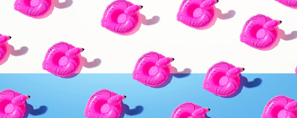 Summer concept with pink flamingo floats - flat lay