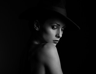 Beautiful makeup woman with elegant healthy neck, nude back and shoulder on black background in fashion hat with empty copy space. Closeup profile view portrait. Art.