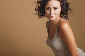 Beautiful woman in the studio. Bright portrait of a young girl on a beige background. High quality photo.