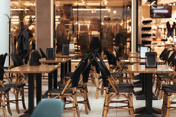 lot of empty tables in the restaurant hall