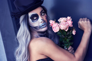 Spooky portrait of woman in halloween gotic makeup knocking on door
