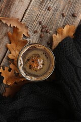 Espresso coffee with a black scarf and oak leaves on the table