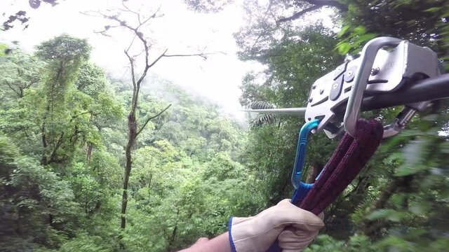 Zip line through rainforest POV with clouds