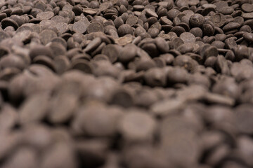 Field of many dark brown chocolat pellets