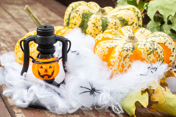 Burning orange lantern in wooden background with pumpkin