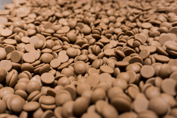 Field of many brown milk chocolat pellets