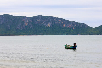 The small motorboat stop on the sea in front of island at thailnad