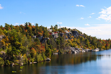 Lake Minnewaska state park in New York with fall colors - view of cliffs and colorful trees