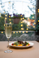 .glass of champagne with salad on bokeh background