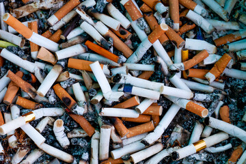 cigarette butts top view, lot cigarette butts and burnt with some ash