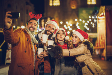 Friends Take Selfie in Downtown At Holiday Night