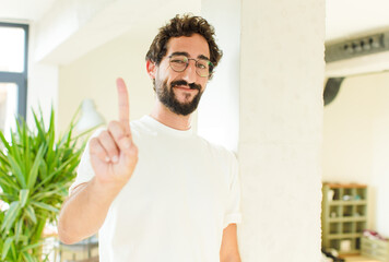 young bearded man at home. proud expression