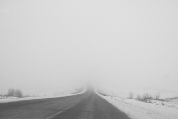 View from the car window. Road in snow