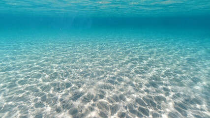 Underwater photo of tropical exotic sandy sea bed with turquoise sea