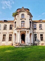 ZHELUDOK, BELARUS - SEPTEMBER 12, 2020: The abandoned manor of Svyatopolk-Chetvertinsky, built in the early 20th century. Popular tourist attraction in Belarus - 384814044