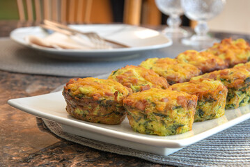 Breakfast Egg Muffins loaded with fluffy eggs, potatoe, spinach, melted cheese and crisp bites of Canadian bacon.