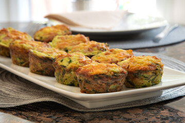 Breakfast Egg Muffins loaded with fluffy eggs, potatoe, spinach, melted cheese and crisp bites of Canadian bacon.