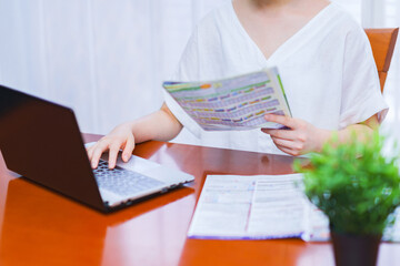 Japanese woman watching catalogue for booking hotel