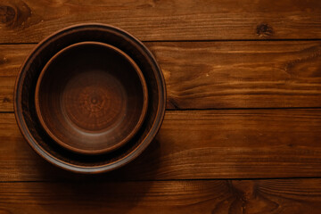 Clay bowls on wooden background