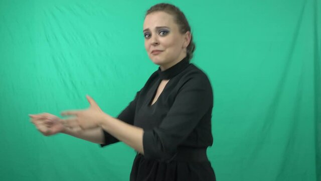 Gorgeous Lady In Green Background Acting For A Charade Game - medium shot