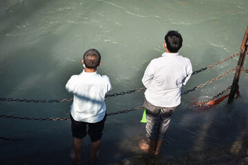 two people doing pooja in haridwar ganga ghat, Uttarakhand Tourism 