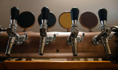 The beer taps in a pub. Nobody. Alcohol concept. Vintage style. Beer craft. 