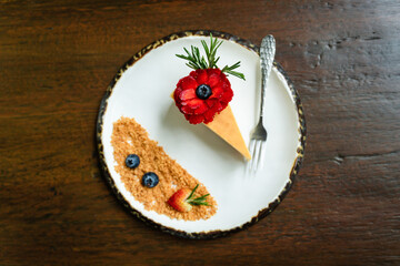 Top view photos of beautifully decorated cakes on white tiled plates and background of old wooden tables