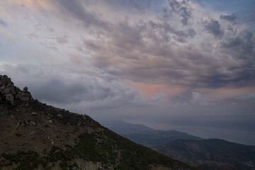 beautiful mountains at sunset against the backdrop of storm clouds