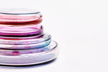 Pyramids from Petri dishes with colorful agar media with bacterial colonies for biochemical analysis in microbiological laboratory with copy space