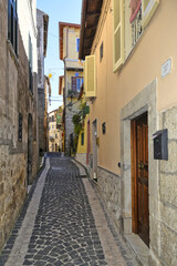 Fototapeta na wymiar An alley among the old houses of Fiuggi, a medieval village in the Lazio region.