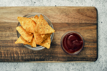 Corn cheese, snacks with sauce on a wooden stand. Beer snack, dish on the menu. Close up.