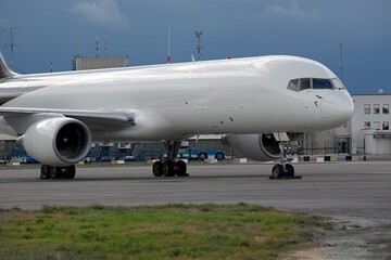 Fototapeta na wymiar Cargo airplane parked at an airport, blank white body
