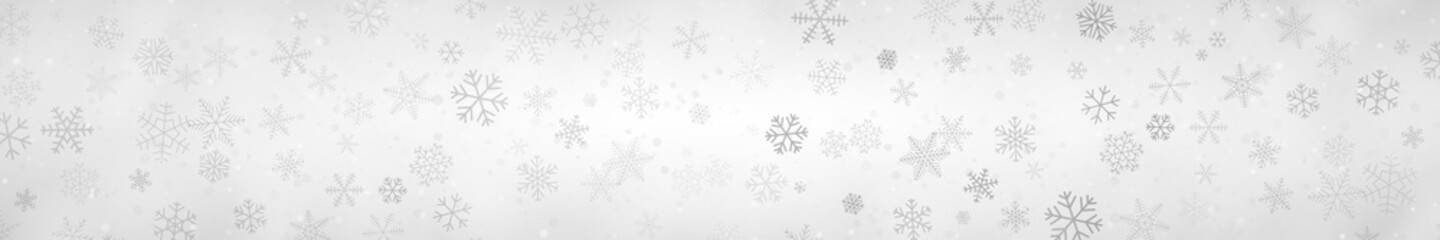 Fototapeta premium Christmas banner of snowflakes of different shapes, sizes and transparency on gray background
